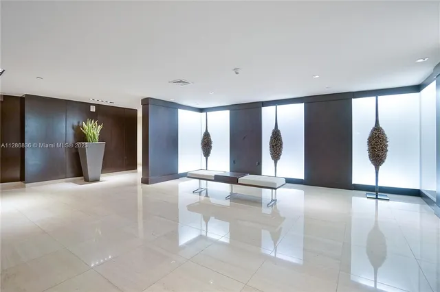 a living room with furniture and large windows