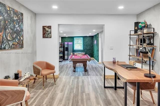 a room with furniture a rug and a book shelf