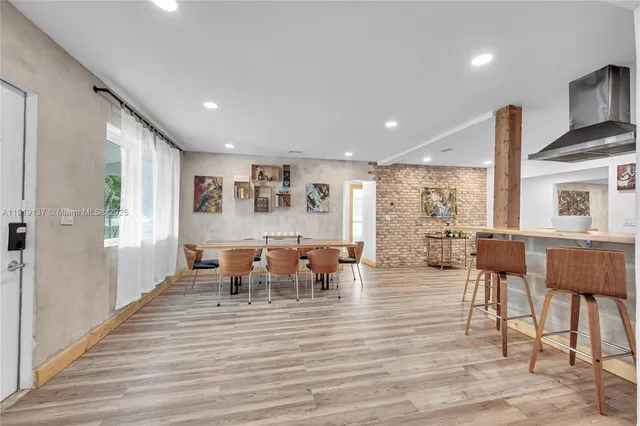 a living room with furniture wooden floor and a table