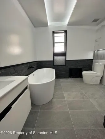 a bathroom with a bathtub and sink