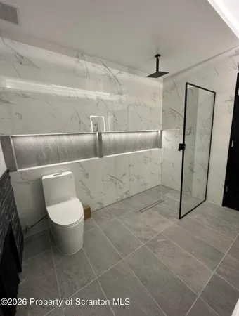 a bathroom with a toilet and a shower
