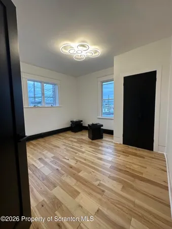 a view of empty room with window and fireplace