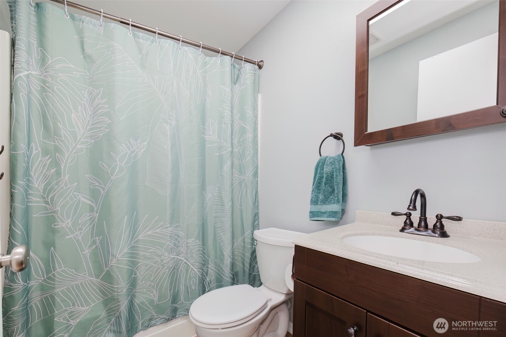 131 Alpine Loop Sequim, WA 98382 - Photo 13 of 19 a bathroom with a sink a toilet and shower curtain