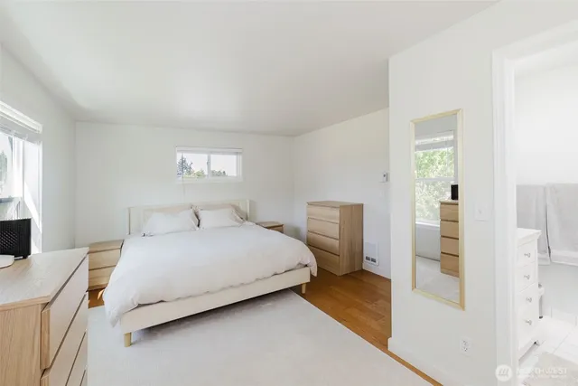 a bedroom with a bed and a lamp