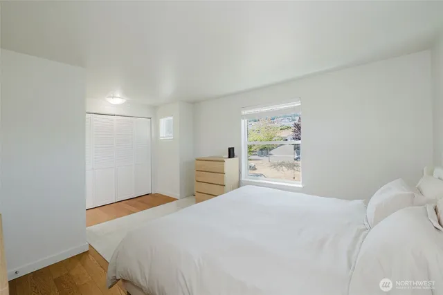 a bedroom with a bed and a window