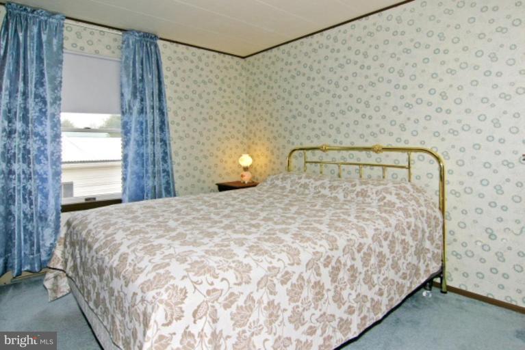 4815 Buffalo Road Mount Airy, MD 21771 - Photo 13 of 19 a bed sitting in a bedroom next to a window and a wooden floor