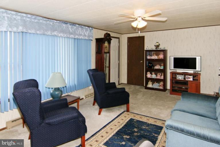 4815 Buffalo Road Mount Airy, MD 21771 - Photo 17 of 19 a living room with furniture and a flat screen tv