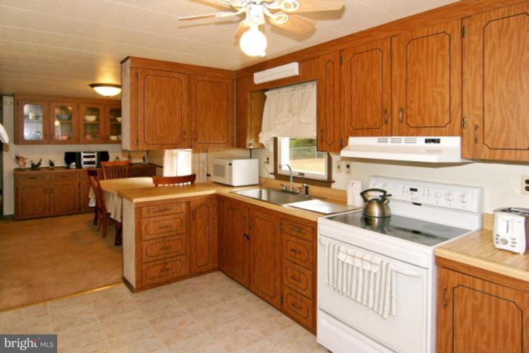 4815 Buffalo Road Mount Airy, MD 21771 - Photo 9 of 19 a kitchen with a sink stove and cabinets
