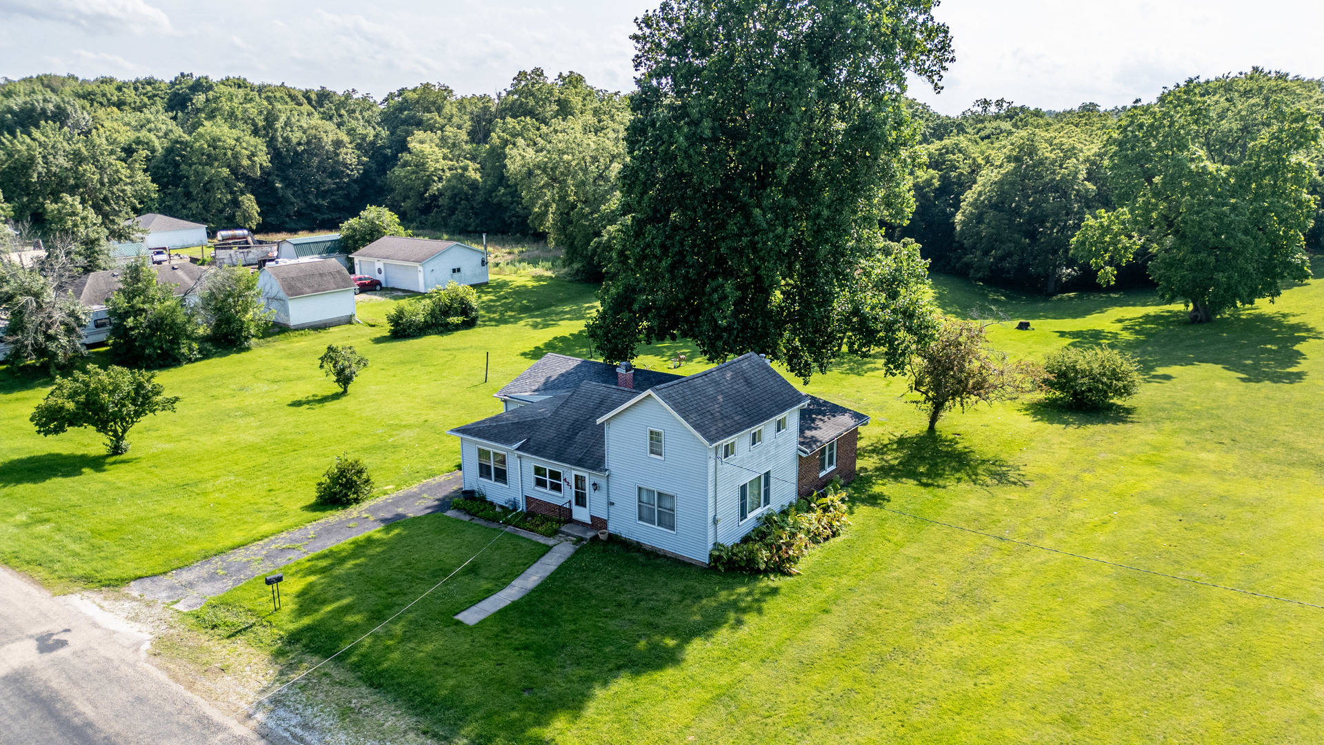 421 South Reed Street Sheffield, IL 61361 - Photo 1 of 28 an aerial view of a house with a yard basket ball court and outdoor seating