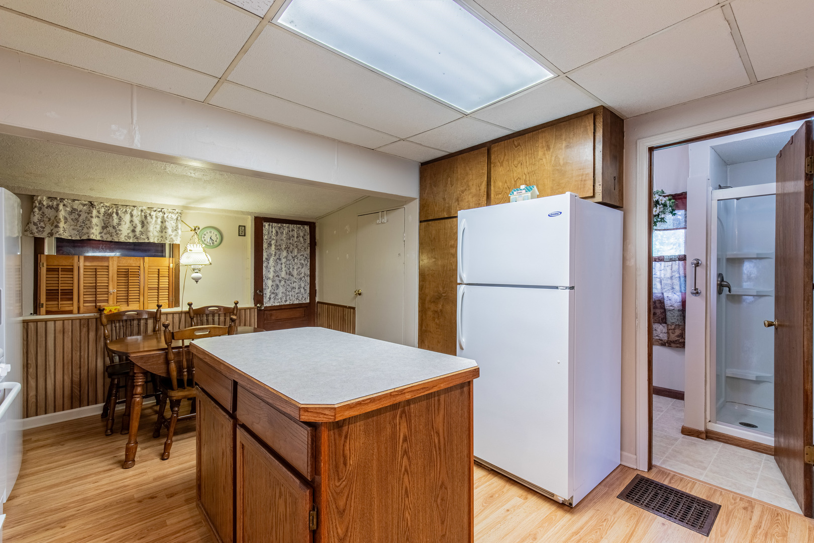 421 South Reed Street Sheffield, IL 61361 - Photo 20 of 28 a kitchen with a refrigerator a table and chairs
