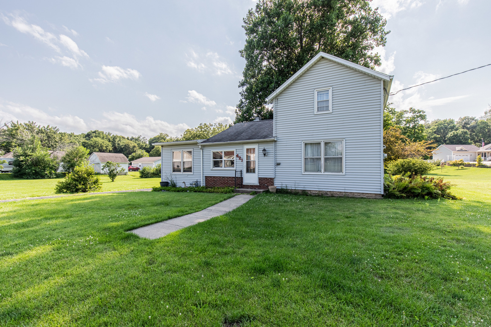 421 South Reed Street Sheffield, IL 61361 - Photo 27 of 28 a view of a yard in front of a house with large windows