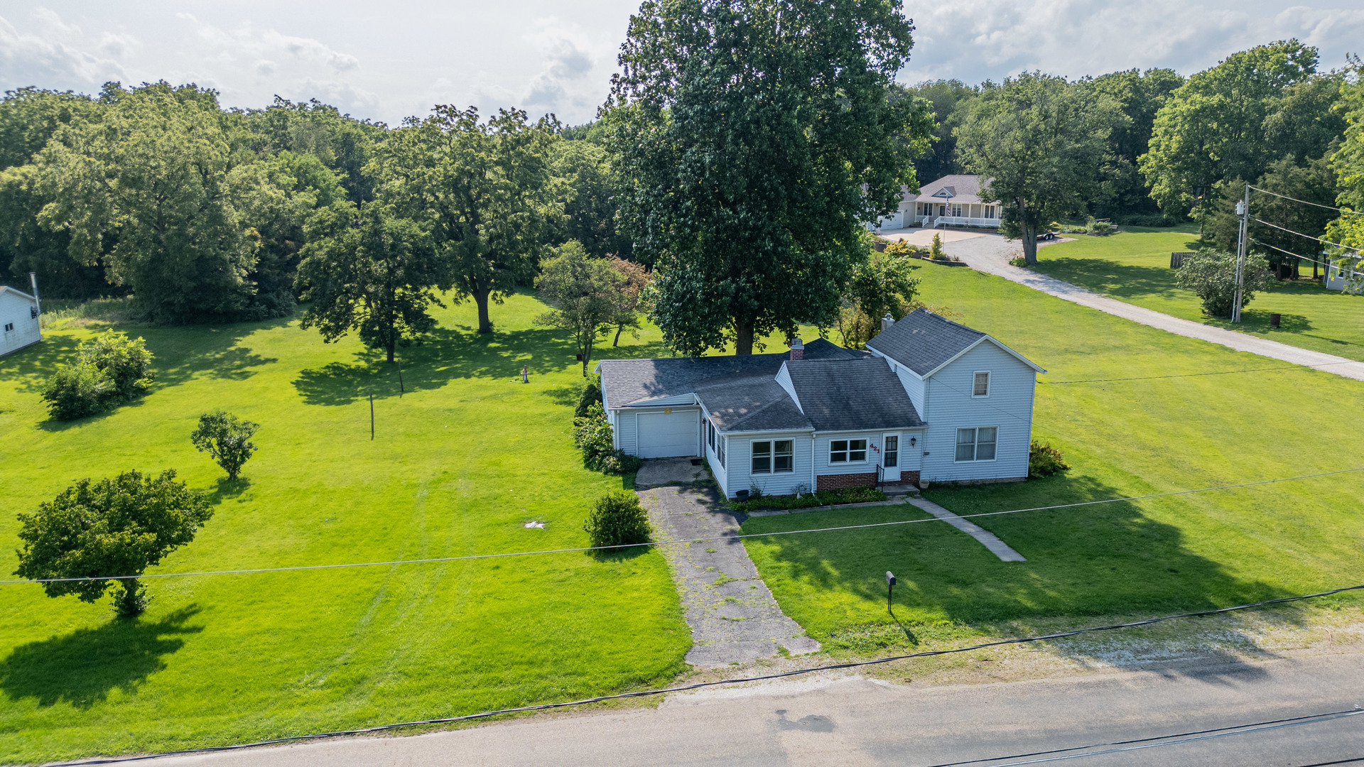 421 South Reed Street Sheffield, IL 61361 - Photo 5 of 28 an aerial view of a house with a garden and swimming pool