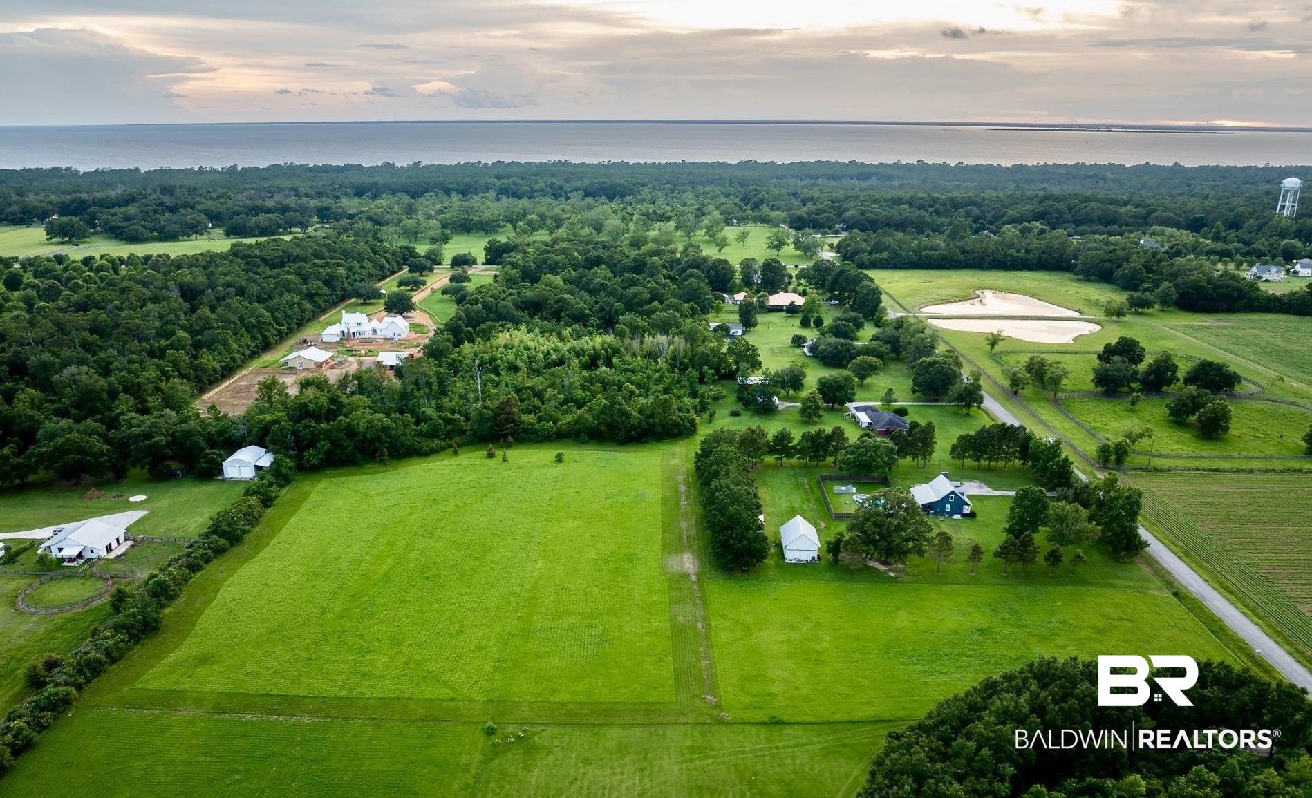 Aerial view at dusk featuring a water view