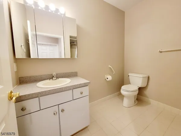 a bathroom with a sink toilet and mirror