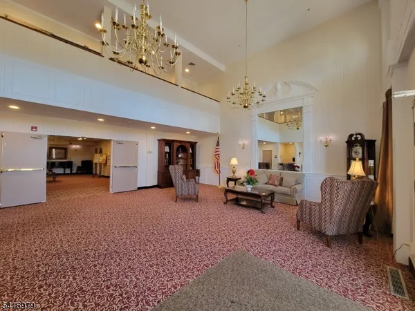 a living room with furniture and a chandelier