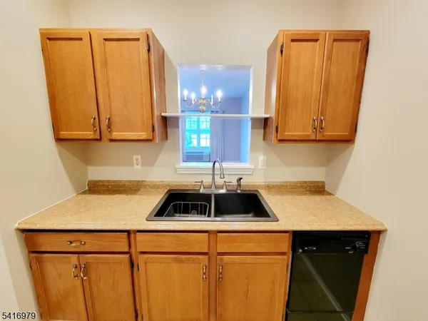 a kitchen with a sink a stove and cabinets