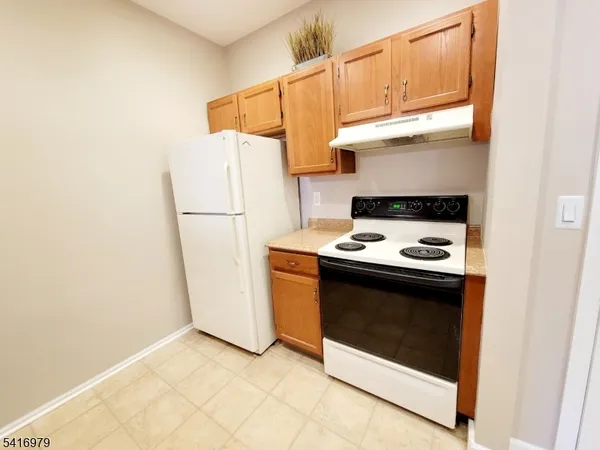 a kitchen with a stove and a refrigerator