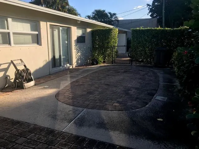 a view of a house with backyard and sitting area