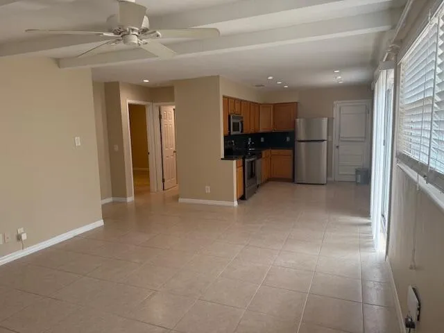 a view of kitchen with refrigerator and window