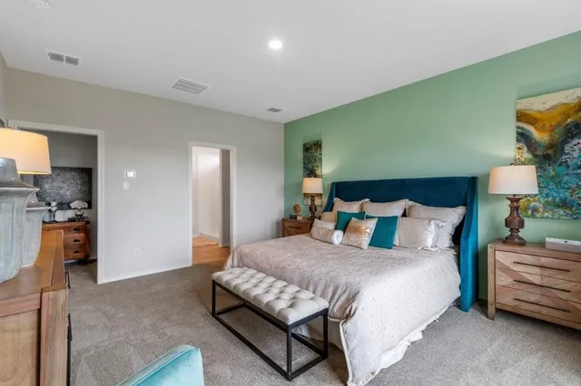 a bedroom with a bed and couch