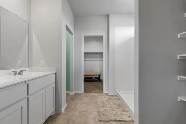 a bedroom with a bed mirror and window