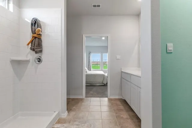 a bedroom with a bed and a view of bedroom