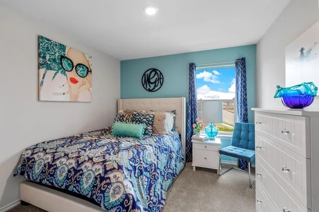 a bedroom with a bed and painting on the wall