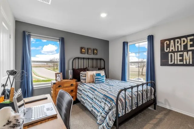 a bedroom with a bed and a painting on the wall