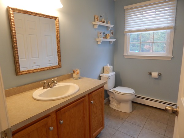 12 Azel Road Freetown, MA 02717 - Photo 12 of 30 a bathroom with a toilet sink vanity and mirror