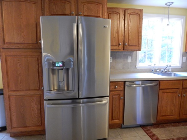 12 Azel Road Freetown, MA 02717 - Photo 9 of 30 a white refrigerator freezer sitting in a kitchen