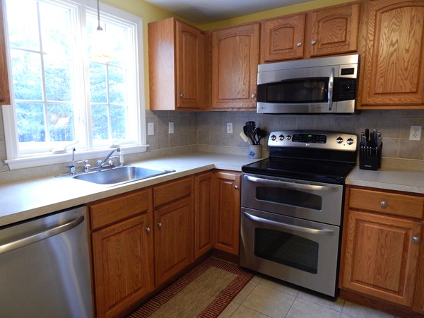 12 Azel Road Freetown, MA 02717 - Photo 10 of 30 a kitchen with a sink stove and microwave