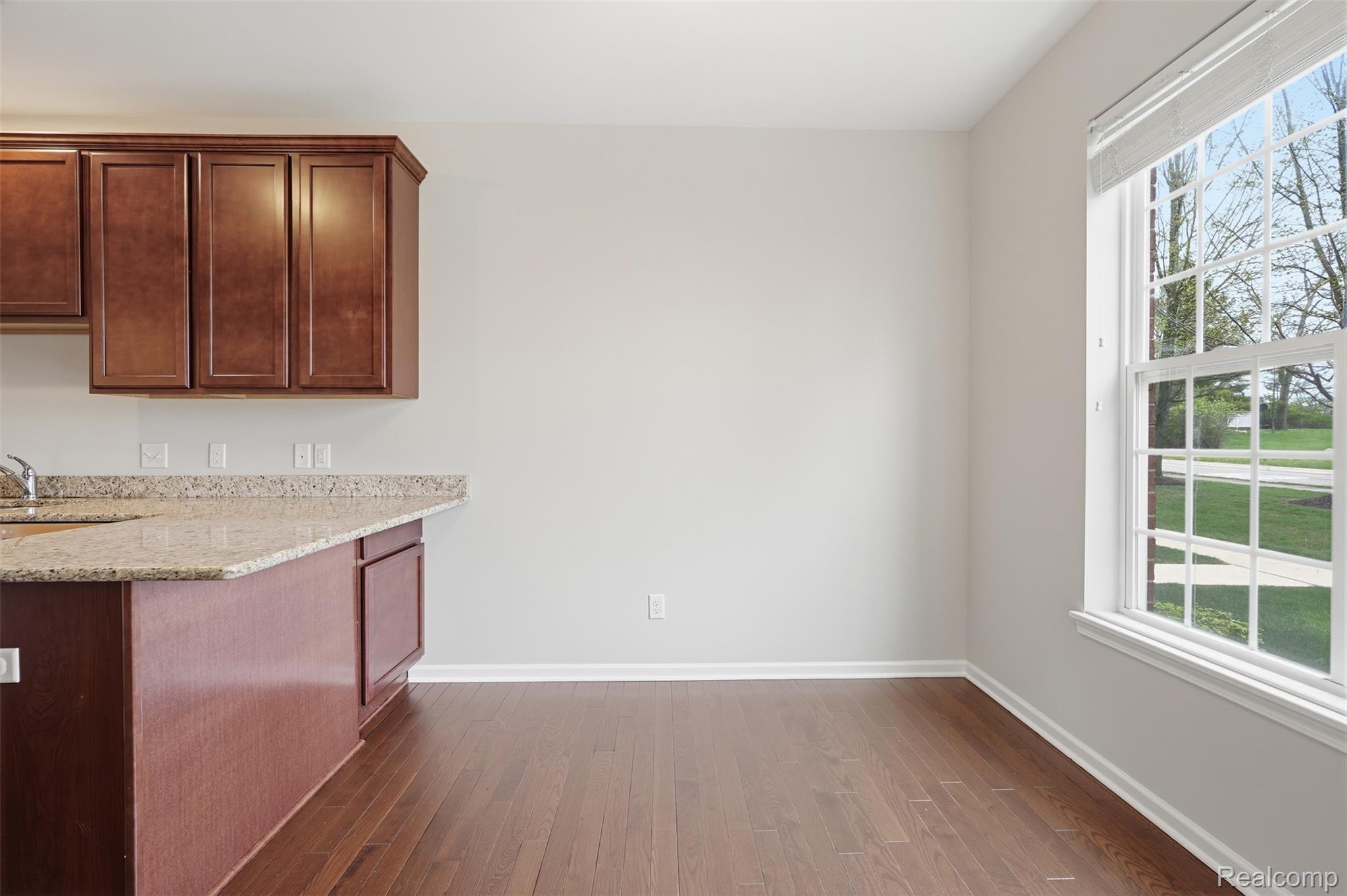 41594 Mitchell Road Novi, MI 48377 - Photo 9 of 35 Unfurnished dining area with dark wood-style floors and baseboards