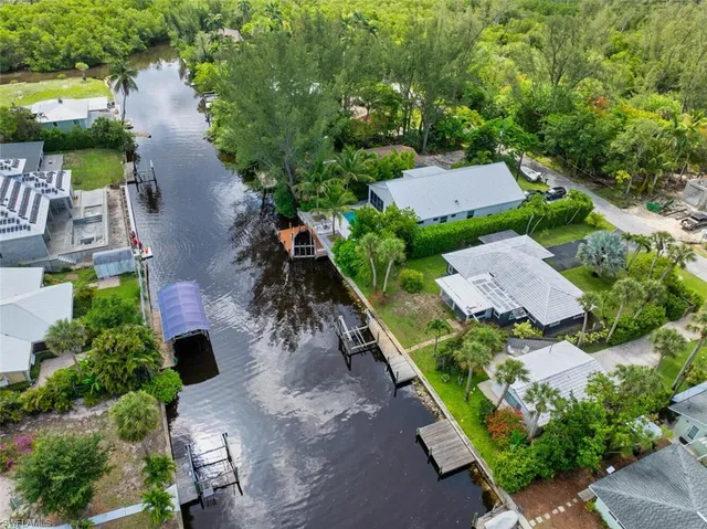 an aerial view of a house with a yard and lake view