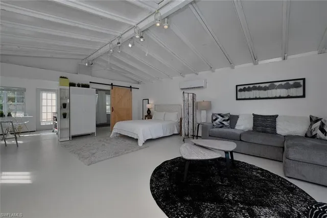 a living room with furniture and a ceiling fan