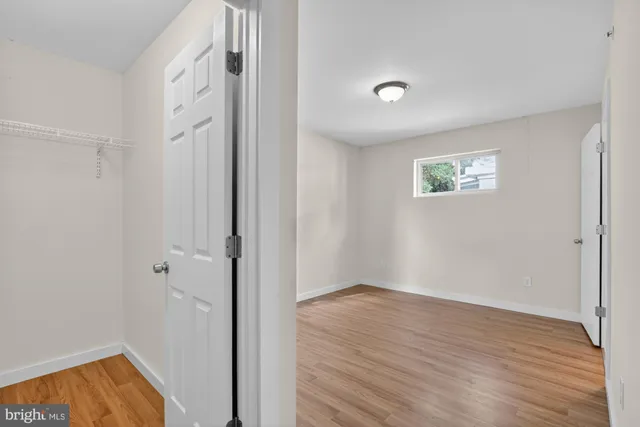 a view of room with wooden floor and window