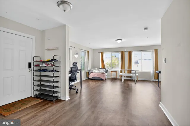 a view of a livingroom with furniture and an empty room