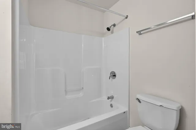 a bathroom with a bathtub and a toilet