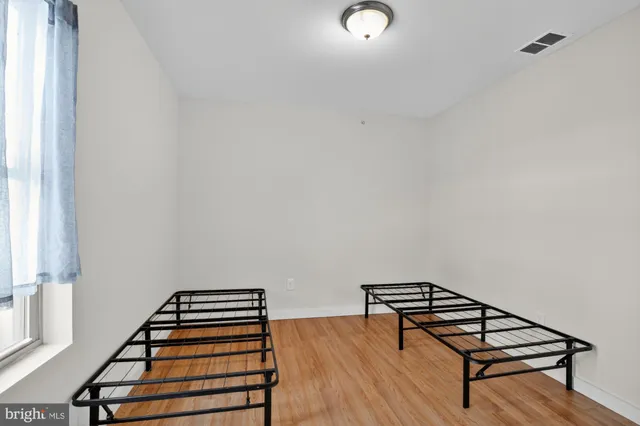 a view of a livingroom with lounge chair and a window