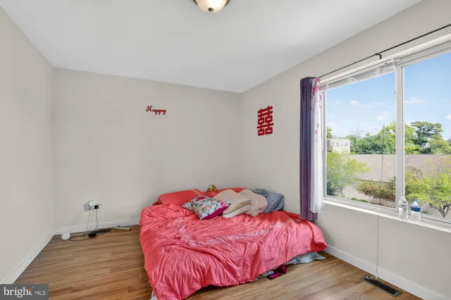 a bedroom with a bed and a large window