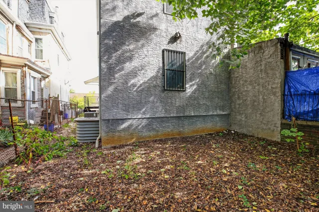 a view of a brick house with a yard