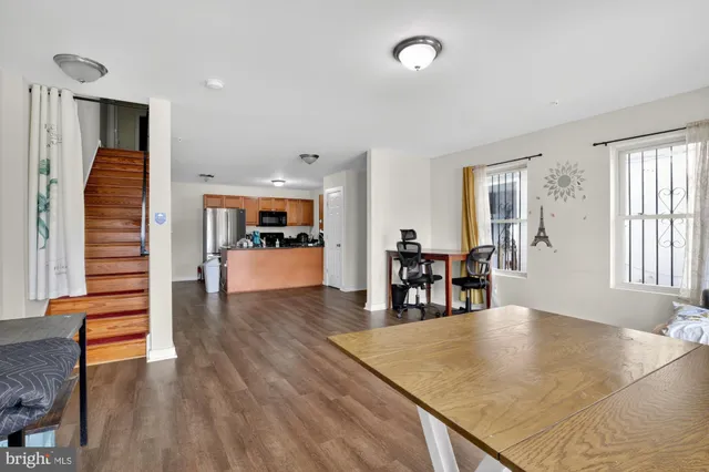 a view of a living room and kitchen floor to ceiling window and kitchen view