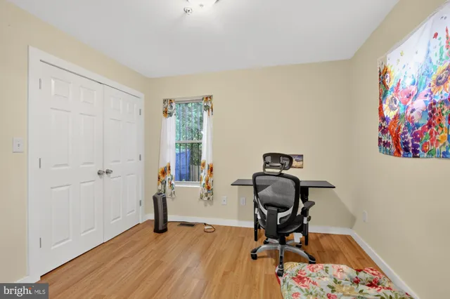 a view of a workspace with furniture and wooden floor