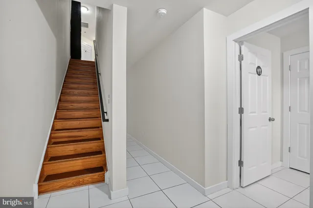 a view of a hallway with wooden floor and entryway