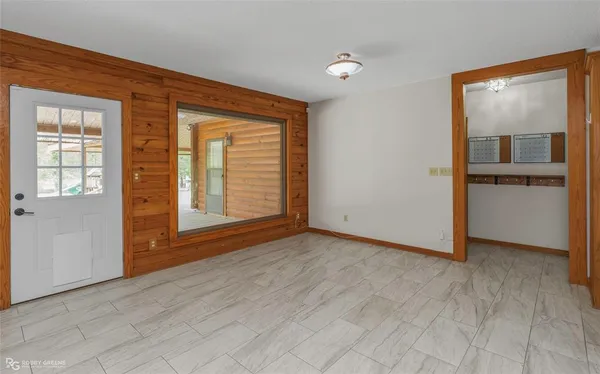 a view of a room with a ceiling fan and a window