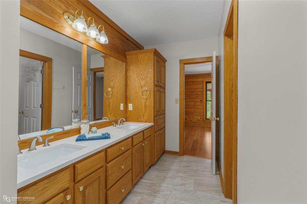 184 Hall Road Stonewall, LA 71078 - Photo 17 of 21 a bathroom with a double vanity sink and a mirror