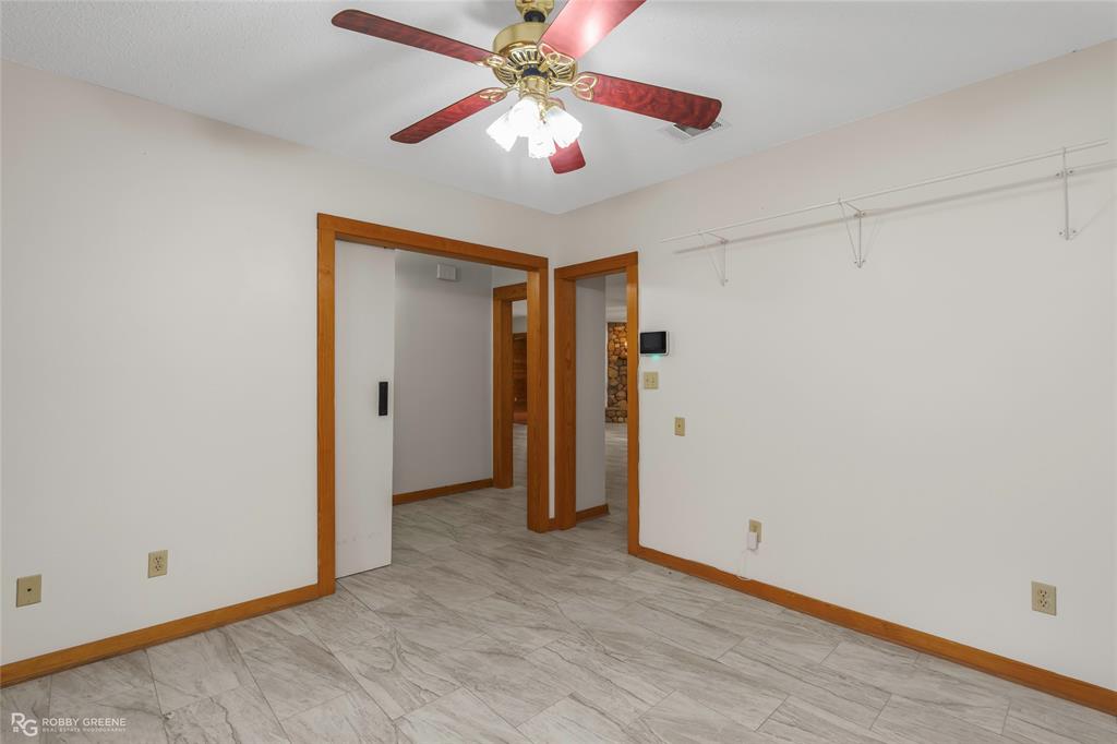 184 Hall Road Stonewall, LA 71078 - Photo 7 of 21 a view of a room with closet and a ceiling fan