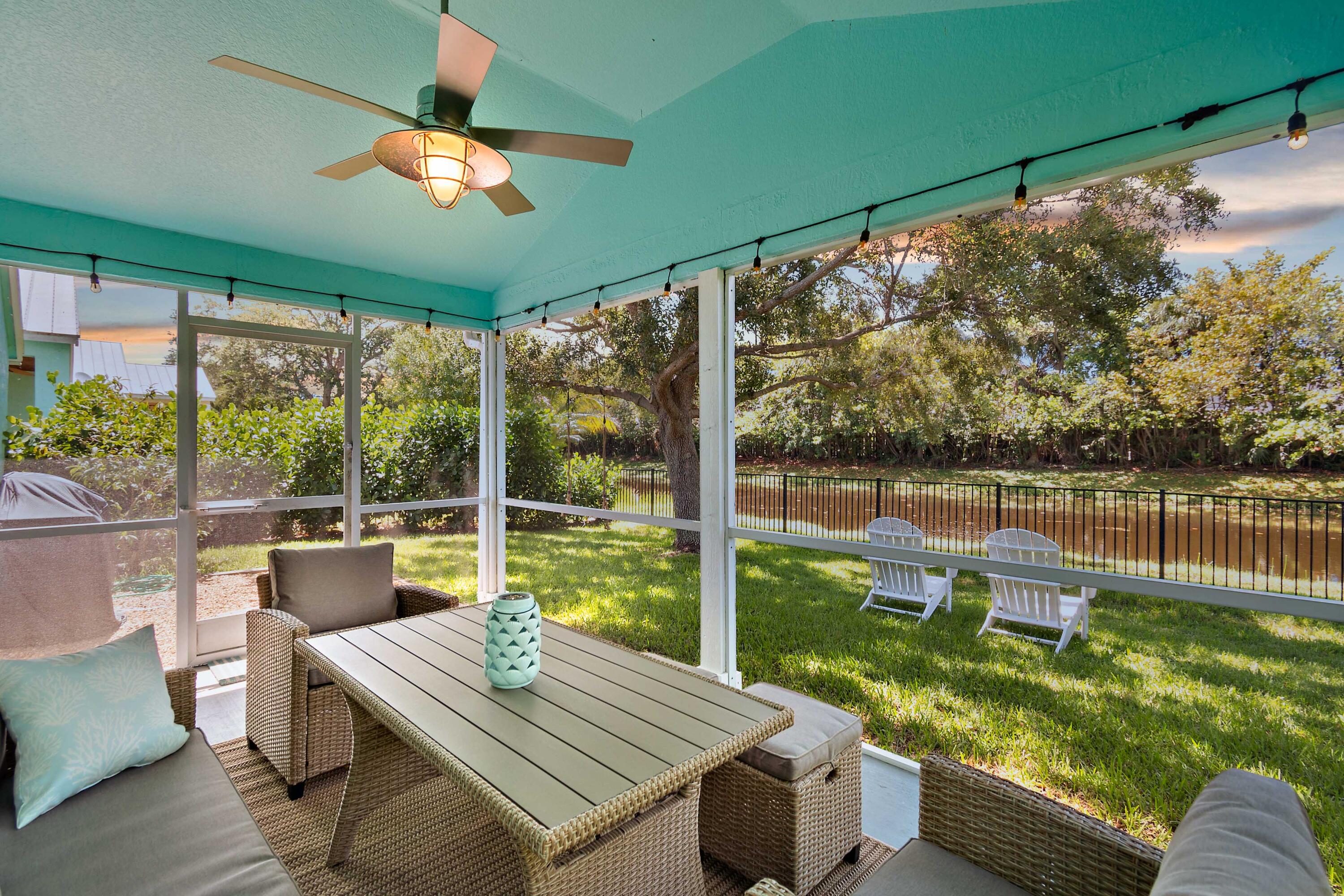 104 Old Jupiter Beach Road Jupiter, FL 33477 - Photo 4 of 17 a view of porch with a table chairs and a floor to ceiling window