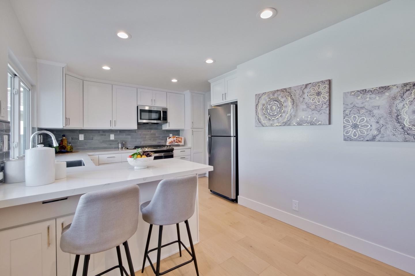 686 Thornapple Drive Sunnyvale, CA 94086 - Photo 25 of 83 a kitchen with stainless steel appliances granite countertop a refrigerator a stove a sink dishwasher and a stove with wooden floor