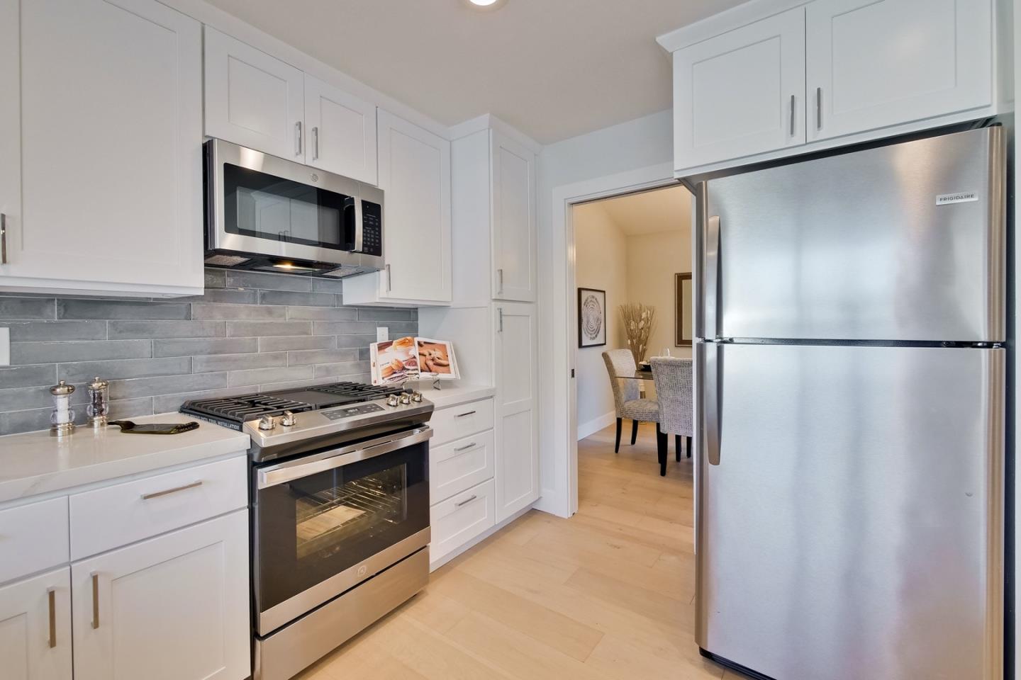 686 Thornapple Drive Sunnyvale, CA 94086 - Photo 32 of 83 a kitchen with stainless steel appliances white cabinets and a granite counter top