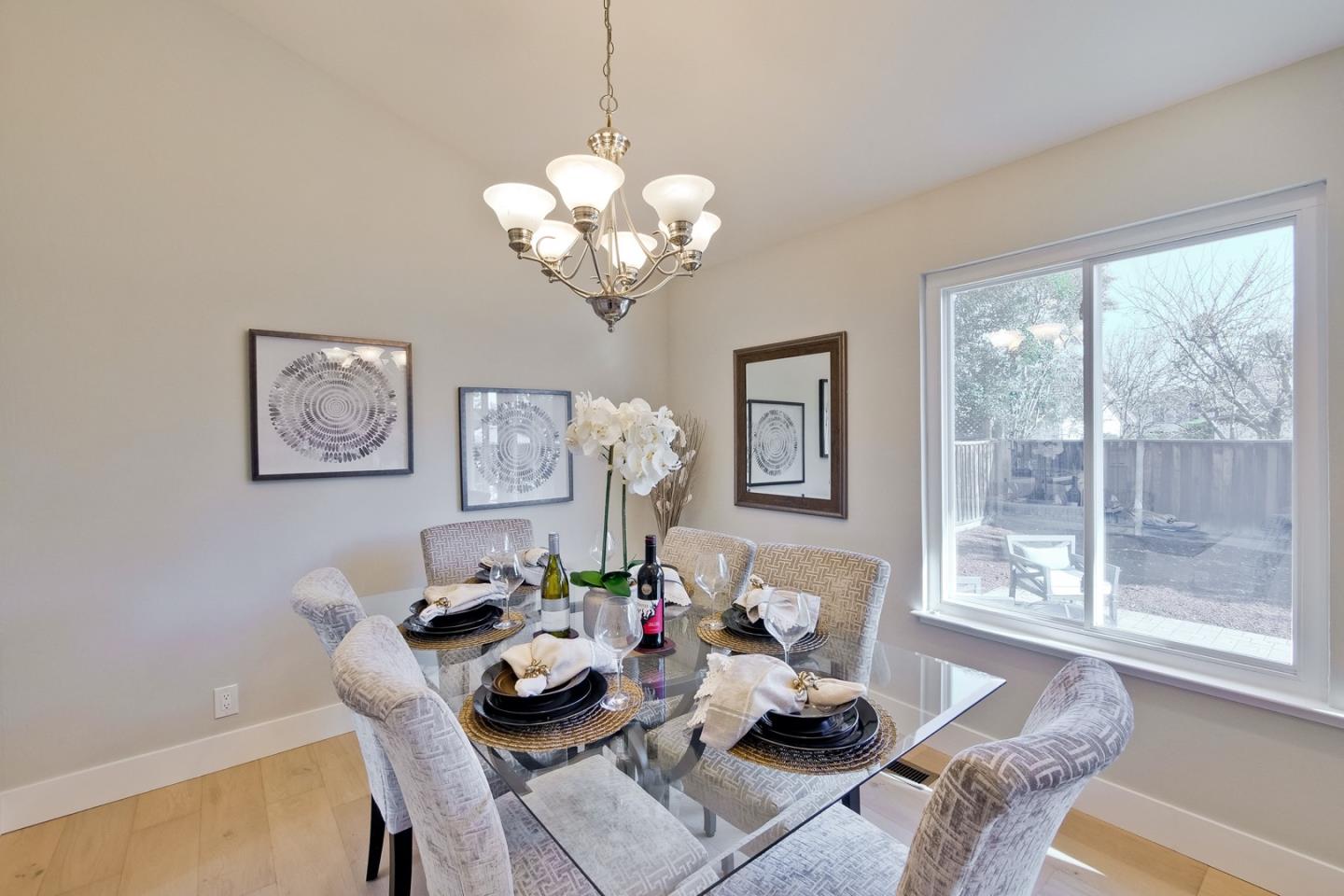 686 Thornapple Drive Sunnyvale, CA 94086 - Photo 34 of 83 a dining room with furniture a large window and a chandelier